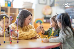 Ocean City moms engaging with children in a colorful classroom setting.